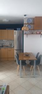 a kitchen with a table with chairs and a refrigerator at Villa Alba in Koinyra