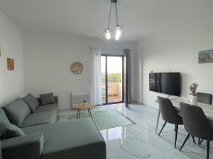 a living room with a couch and a tv at Relax apartment, Side Sea View, Golem, Albania in Golem