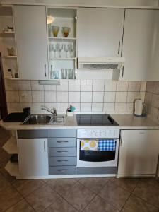a kitchen with a sink and a stove at Apartman Ivo, Bol in Bol