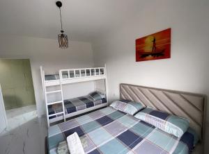 a bedroom with a bed and bunk beds at Relax apartment, Side Sea View, Golem, Albania in Golem +29 photos