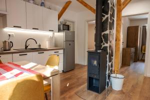 a kitchen with a stove in the middle of a room at Villa Boca in Nižná Boca