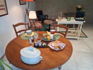 a table with a tea pot and food on it at Chambre de l'Iris in Sainte-Croix-sur-Mer