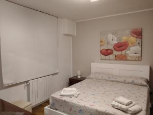 a bedroom with a bed with towels on it at Casabella Mondello in Mondello