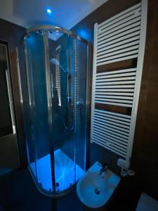 a bathroom with a glass shower and a sink at Casa Plauto con appartamento grande in Bellaria-Igea Marina