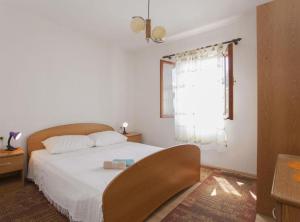 a bedroom with a bed and a window at House B - 45m from the Sea in Vela Luka +19 photos