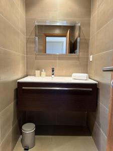 a bathroom with a sink and a mirror at T4 Cote Plage N6 face a la mer in Pinarellu +17 photos