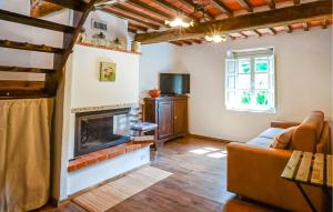 a living room with a fireplace and a couch at Casa Sant'anna in Stazzema