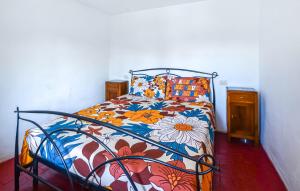 a bedroom with a bed with a floral bedspread at Casa Sant'anna in Stazzema