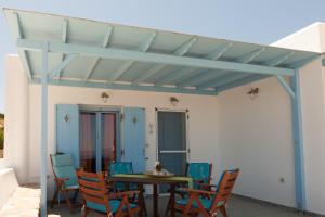 a patio with a table and chairs under awning at Ergina Summer Resort in Antiparos