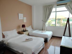 Postel nebo postele na pokoji v ubytování Natol Homestay - Kuching Home Penthouse Airport Road
