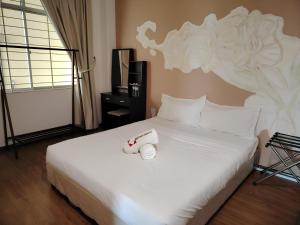 Postel nebo postele na pokoji v ubytování Natol Homestay - Kuching Home Penthouse Airport Road