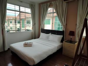 Postel nebo postele na pokoji v ubytování Natol Homestay - Kuching Home Penthouse Airport Road