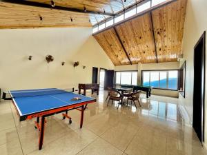 a room with a ping pong table and chairs at The Dunhill Manor in Lansdowne +28 photos