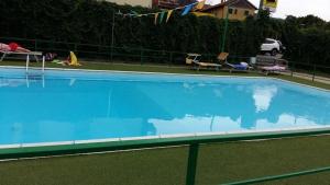 a large blue swimming pool in a yard at La Casetta in Calizzano