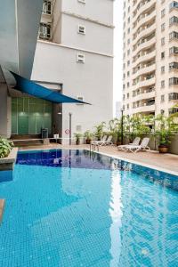 a large blue swimming pool in a building at Seri Bukit Ceylon Bukit Bintang in Kuala Lumpur