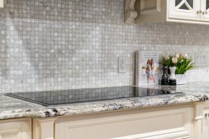 a kitchen with a counter top with white tiles at The Royal Ravine Luxury Retreat in Calgary +53 photos
