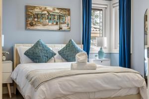 a bedroom with blue walls and a bed with blue curtains at The Royal Ravine Luxury Retreat in Calgary