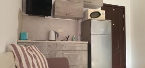 a small kitchen with a refrigerator and a microwave at Квартира студия Villa Astoria 2 Болгария Солнечный берег in Elenite +14 photos