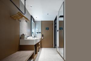 a bathroom with a sink and a mirror at Atour Hotel Shenfu Avenue Hunnan District in Shenyang +11 photos
