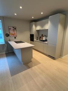 a kitchen with a island in the middle of a room at Apartment in the heart of Ålesund city in Ålesund