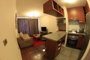 a small kitchen and living room in a small apartment at Departamentos amoblados Don Matias en Concepción in Concepción