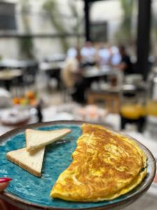 a plate of food with a pancake and a cookie at Palazzo Kapece in Monopoli