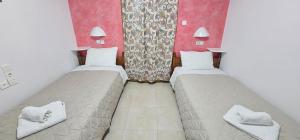 Ліжко або ліжка в номері Hotel Palladion