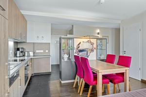 a kitchen and dining room with a table and chairs at Resort Deichgraf Resort Deichgraf 27-21 in Wremen