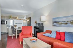 a living room with a couch and chairs and a table at Resort Deichgraf Resort Deichgraf 31-13 in Wremen