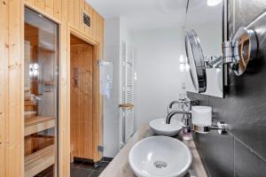 a bathroom with a sink and a toilet and a mirror at Resort Deichgraf Resort Deichgraf 31-13 in Wremen +7 photos