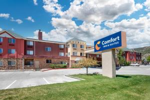 a sign for a comfort inn in a parking lot at Comfort Inn & Suites Durango in Durango