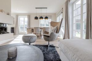 a bedroom with a bed and a dining room at Haus Strandhafer in List