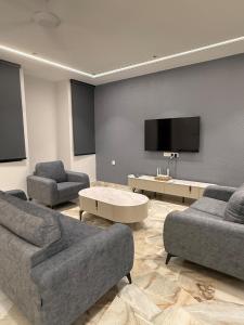 a living room with two couches and a flat screen tv at LiveLikeYourHome, RajaUda Butterworth 