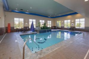 a large indoor swimming pool in a building at Comfort Suites Troy-I75 in Troy