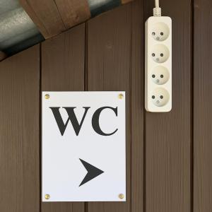 aww sign on a wall next to a wii controller at Bed in Bus in Kolárovice +2 photos