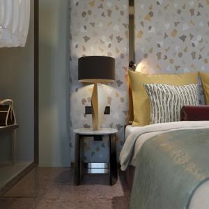 a bedroom with a bed and a lamp on a table at Palazzo Rota Luxury Apartments in Venice