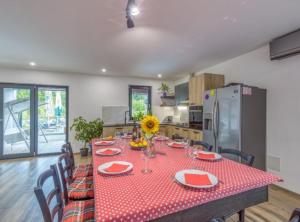 a kitchen with a table with a red tablecloth on it at Holiday Home Mali Raj in Ogulin +32 photos