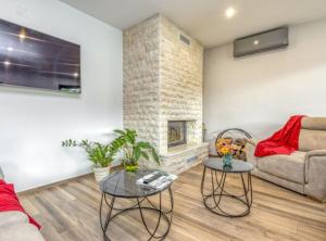 a living room with a couch and a fireplace at Holiday Home Mali Raj in Ogulin