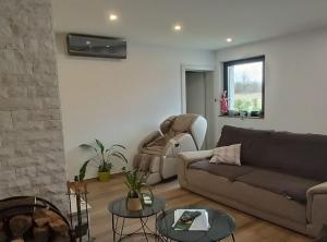 a living room with a couch and a chair at Holiday Home Mali Raj in Ogulin