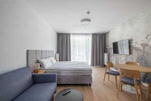Postel nebo postele na pokoji v ubytování Łeba Boutique Apartments
