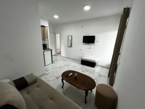 a living room with a couch and a table at Apartmani Musić in Ulcinj