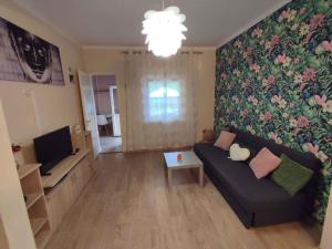 a living room with a couch and a tv at Holiday home in Siofok - Balaton 45810 in Siófok