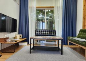a living room with a couch and a coffee table at Sehwa Stay in Jeju