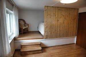 a room with a bed and a wooden wall at Ferienwohnung Im Münchner - Süden in Schäftlarn