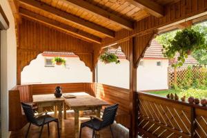 a wooden pergola with a wooden table and chairs at Apartment in Balatonkeresztur 48113 in Balatonkeresztúr