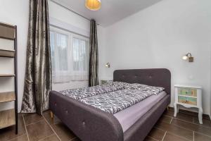 a bedroom with a bed in a room with a window at Holiday home in Balatonbereny 42284 in Balatonberény