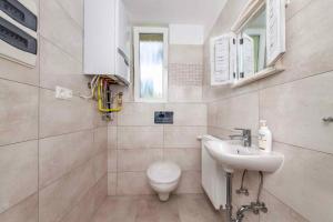 a bathroom with a toilet and a sink at Holiday home in Balatonbereny 42284 in Balatonberény +8 photos