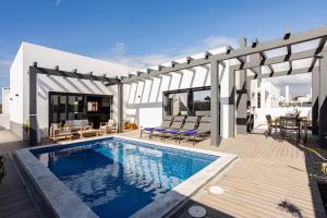 a house with a swimming pool and a patio at Villa Sal - Porto Covo in Porto Covo
