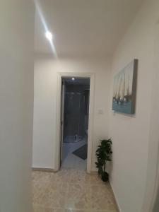a hallway with a room with a toilet and a painting at Cozy Seaview Apartment Sliema S6 in Sliema