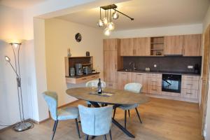 a kitchen with a dining room table and chairs at Ferienwohnung Eder in Bad Birnbach +4 photos